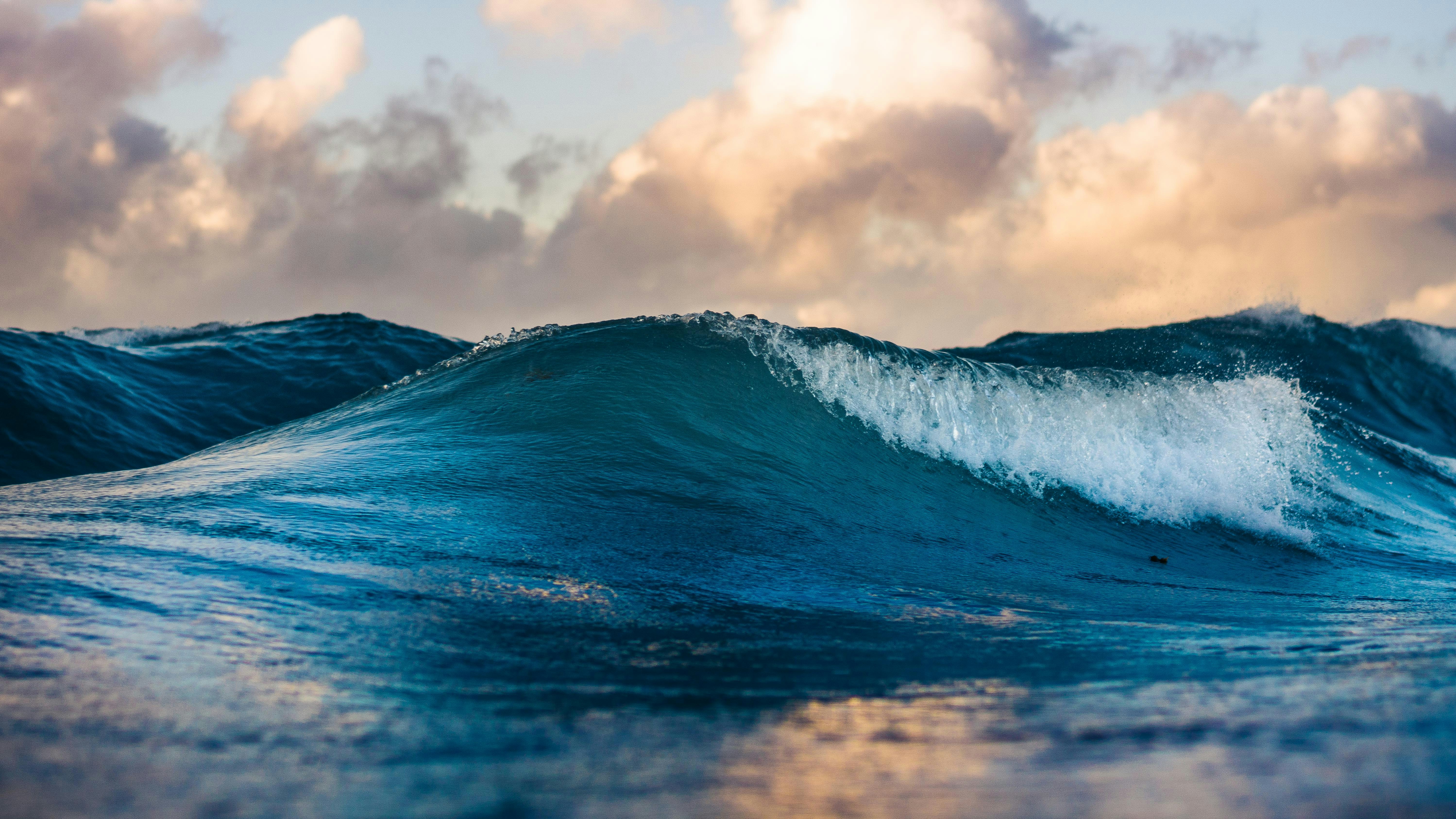 Ocean wave breaking at golden hour